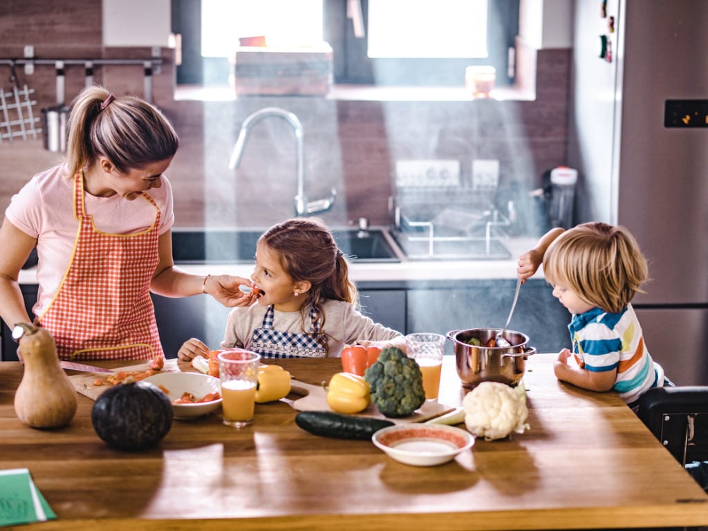 happy-mother-and-her-kids-enjoying-in-meal-preparation-in-the-kitchen-picture-id1069478668(1).jpg